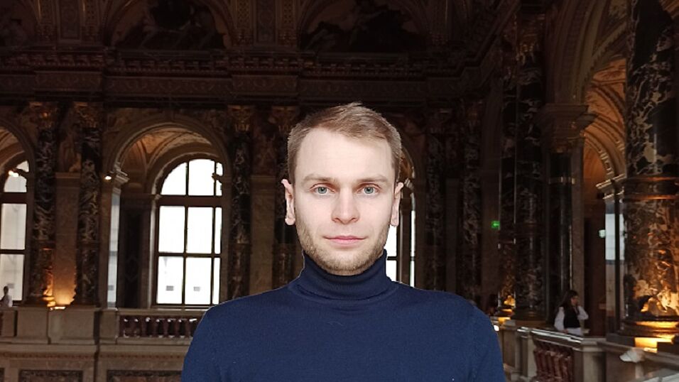 Serhii Bardyla, PhD, head of him with blue pullover and blond hair, in a museum